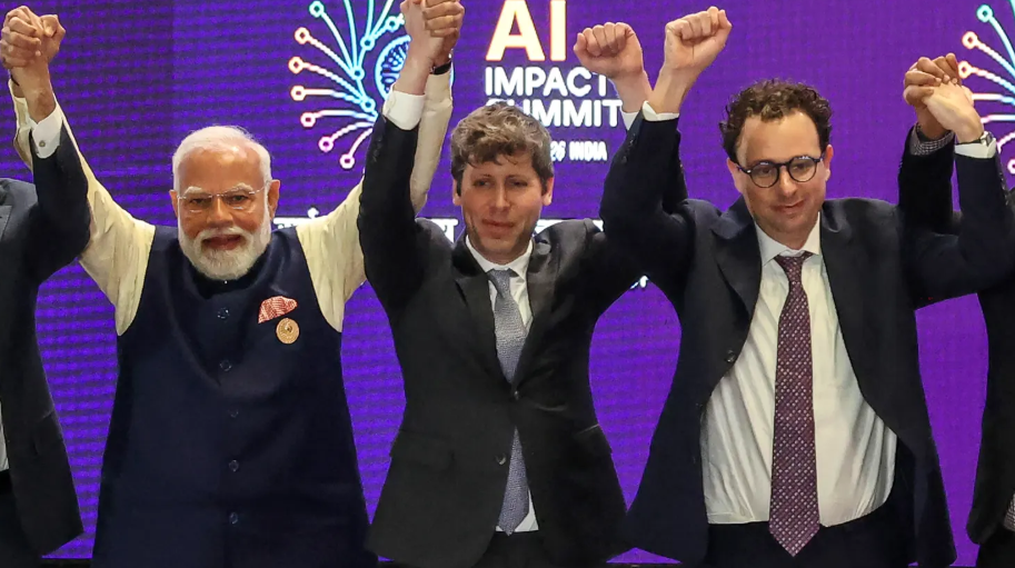 India’s Prime Minister Narendra Modi (L) takes a group photo with AI company leaders including OpenAI CEO Sam Altman (C) and Anthropic CEO Dario Amodei (R) at the AI Impact Summit in New Delhi on February 19, 2026.