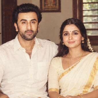 AI-generated image for representational purposes only. The image is a creative recreation inspired by Alia Bhatt and Ranbir Kapoor in a nostalgic 1980s Malayali family portrait style. It is not an actual photograph from the 1980s.